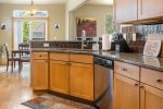 Kitchen w stainless steel appliances, granite slab counter tops